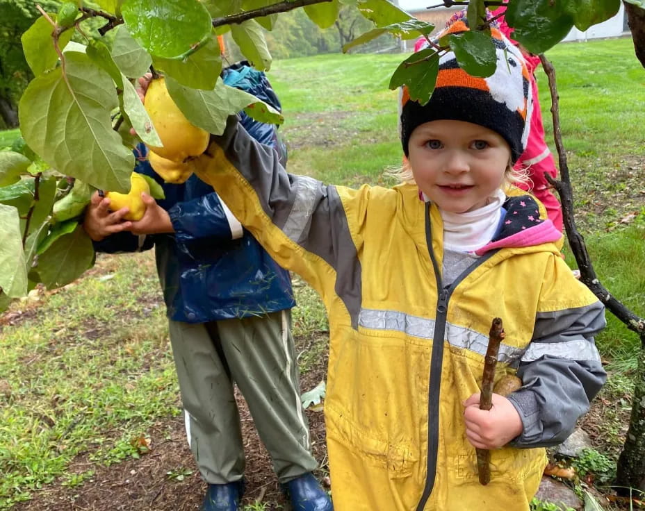 a boy and a girl holding fruits