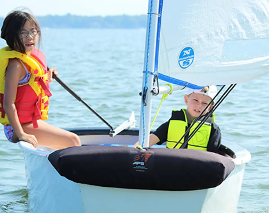 a man and a woman on a sailboat