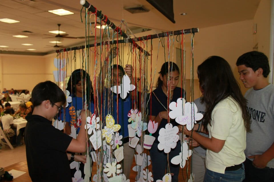 a group of people looking at a toy