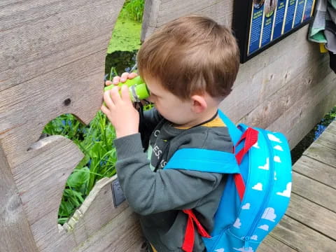 a child holding a green object