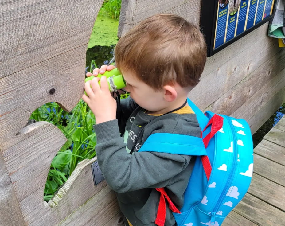 a child holding a green object