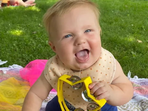 a baby holding a toy