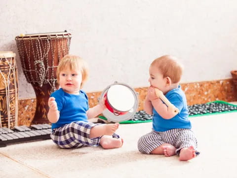 two kids sitting on the floor