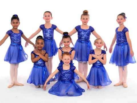 a group of girls in blue dresses