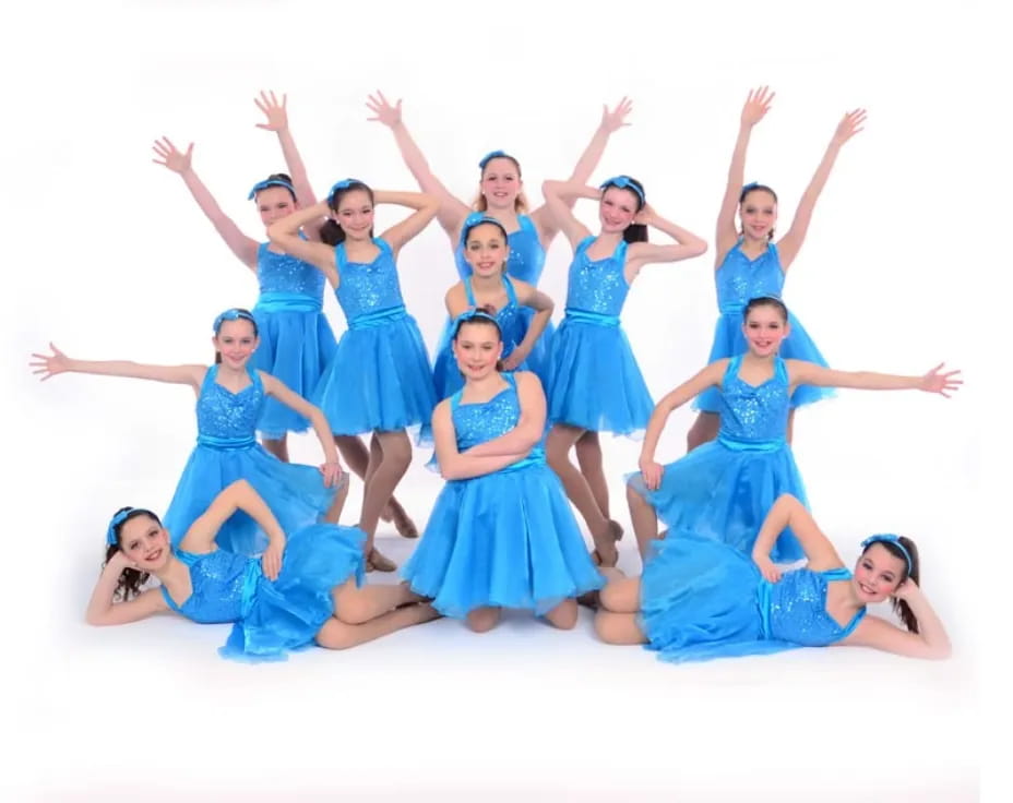 a group of women in blue dresses