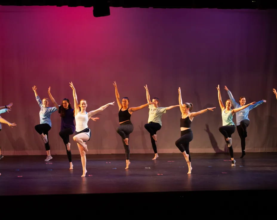 a group of women dancing on a stage