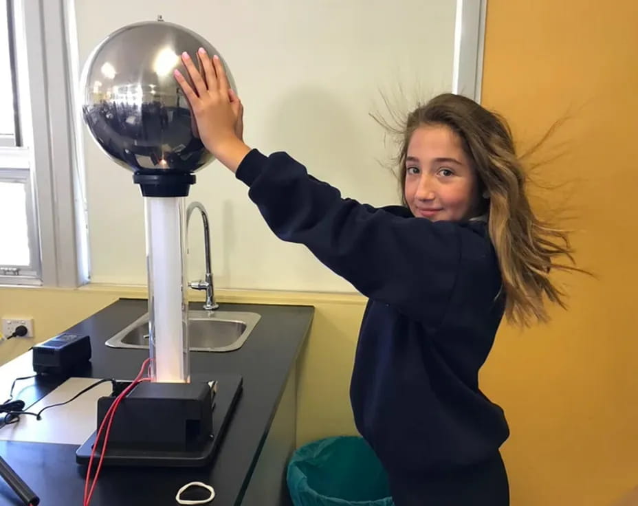 a person holding a silver trophy