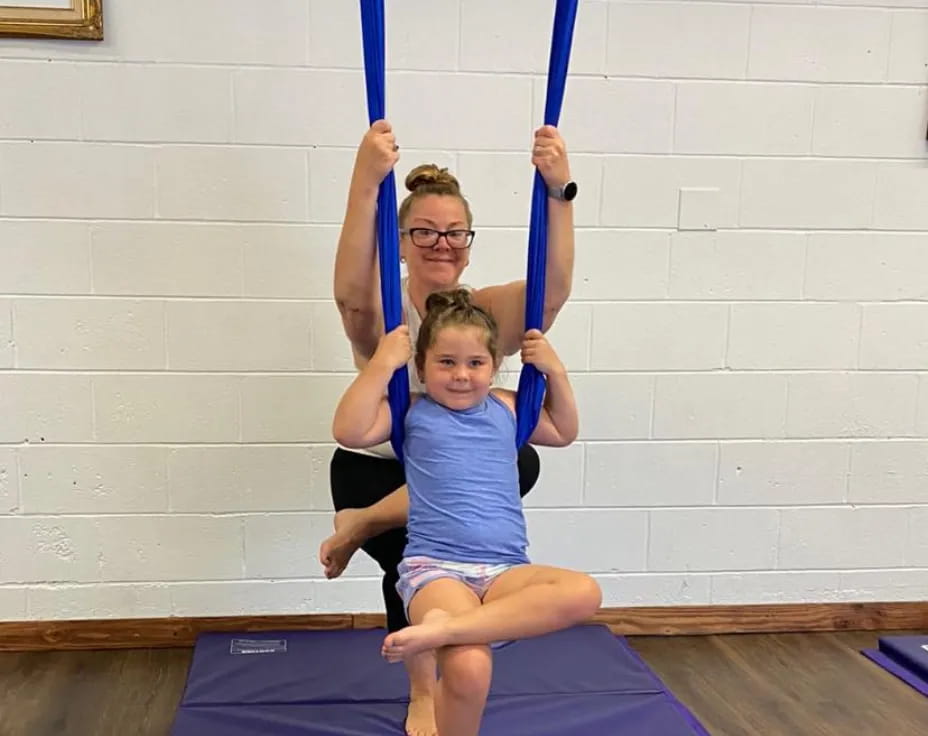 a woman and a child on a swing