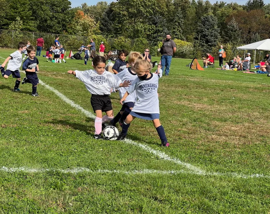 kids playing football on a field