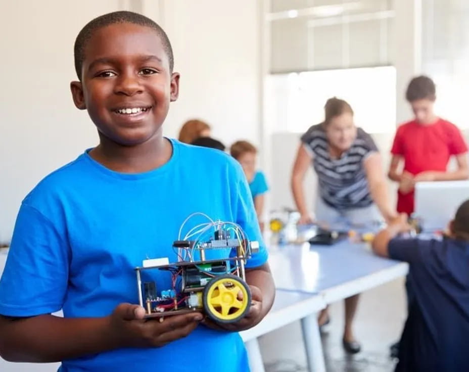 a boy holding a toy car