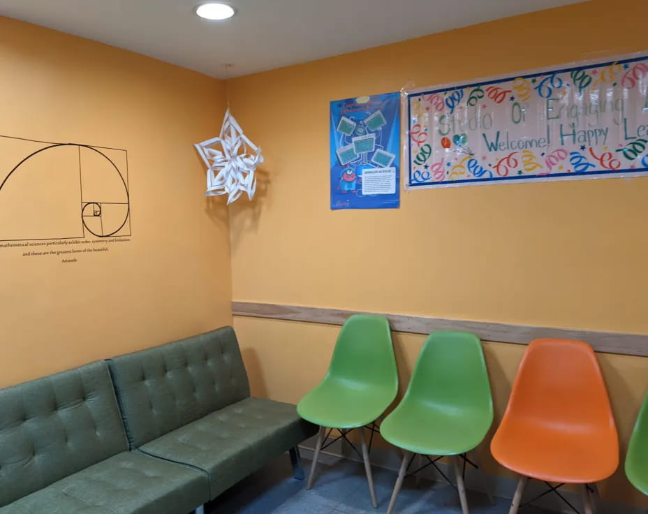 a classroom with green chairs