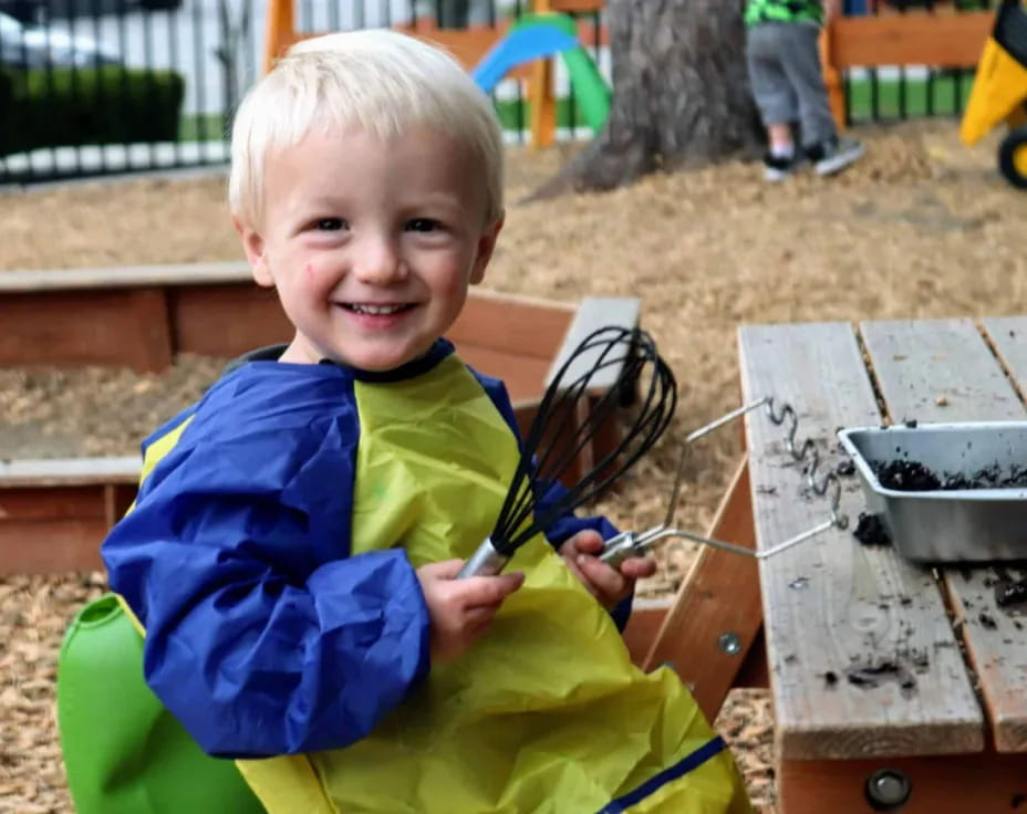 a boy holding a fork and knife