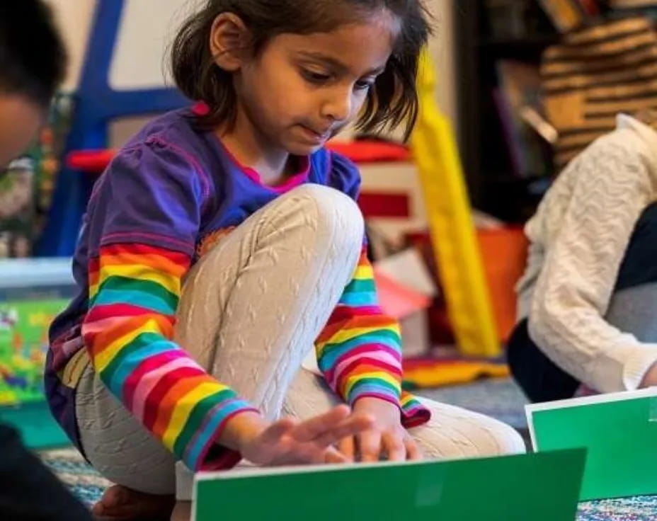 a young girl using a laptop