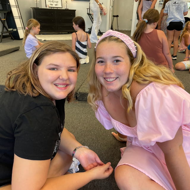 a couple of girls posing for the camera