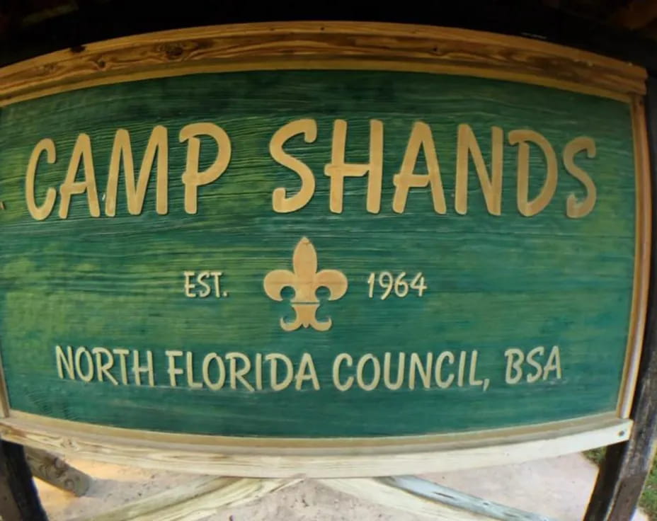 a sign on a wood post