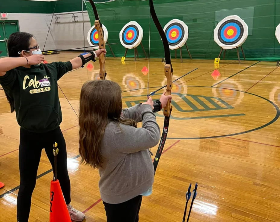 a couple of people shooting bows