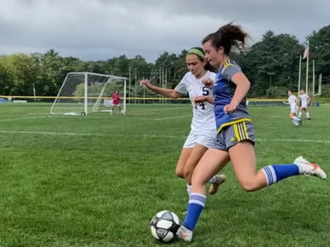girls playing football on a field