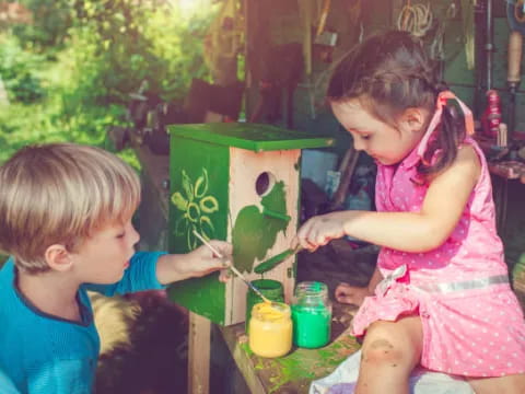 a couple of children painting