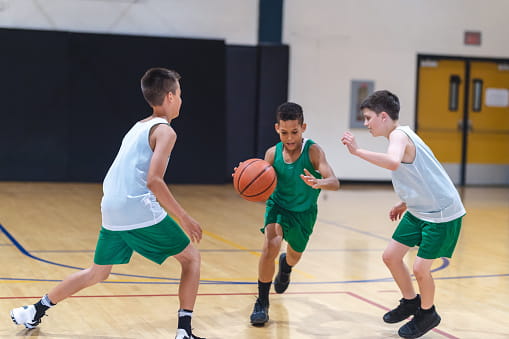 a group of boys playing basketball
