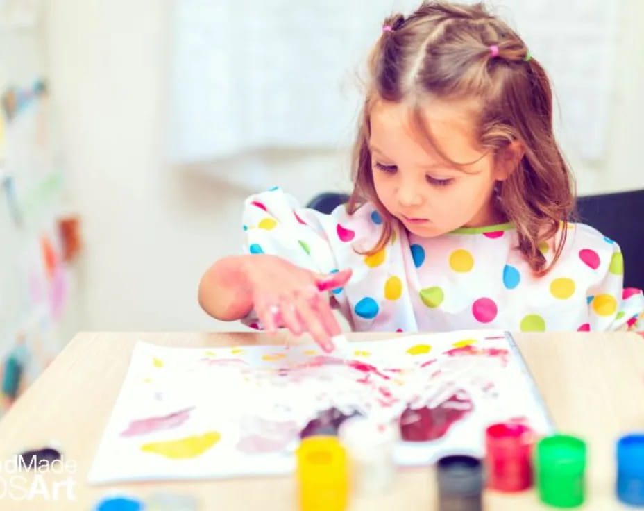 a girl coloring on a paper