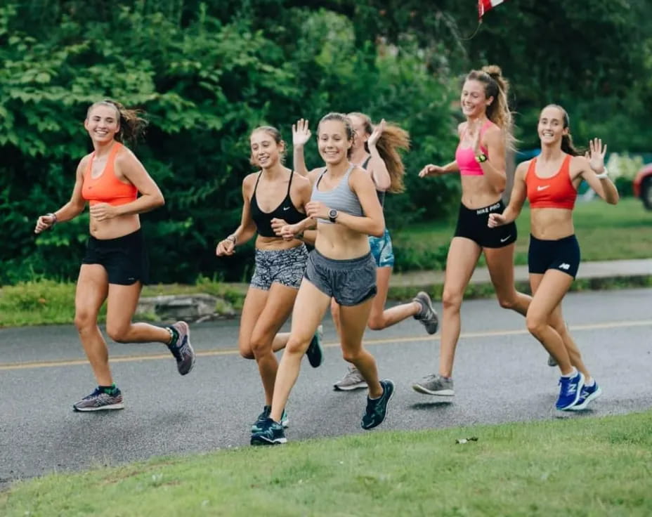 a group of women running on a road