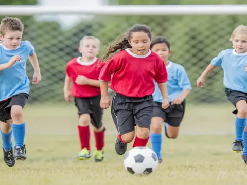 a group of kids playing football