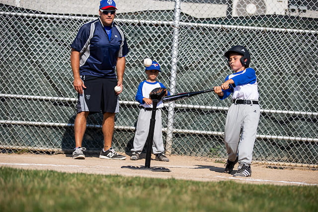 a kid holding a baseball bat