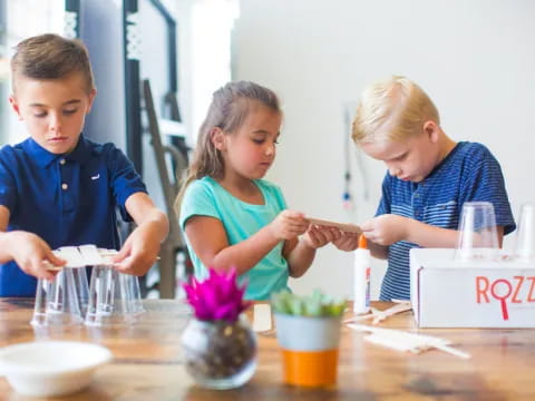 a few children working on a plant