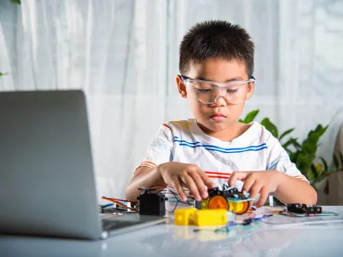 a boy using a laptop
