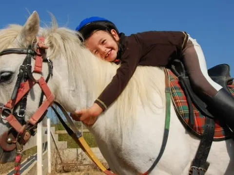 a man riding a white horse