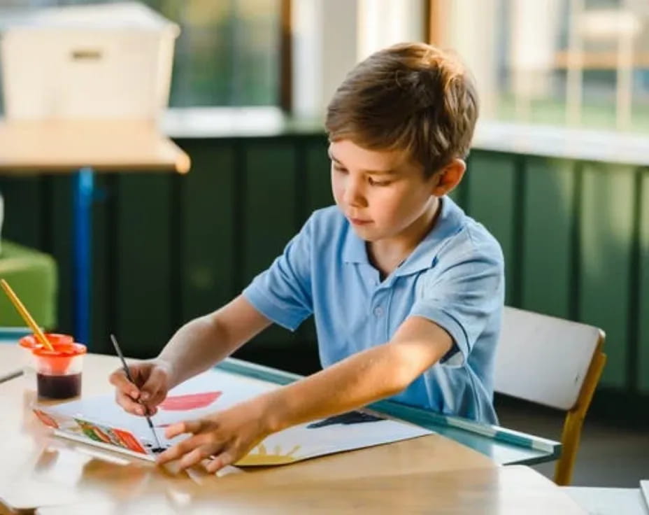 a young boy sitting at a table