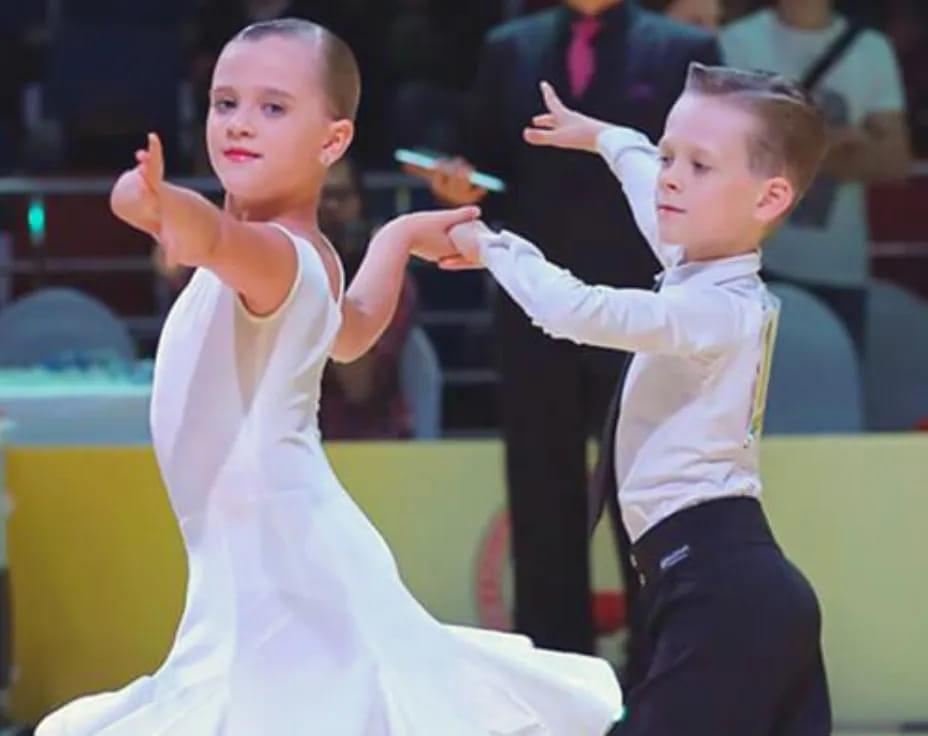 a couple of children dancing