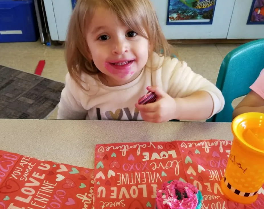 a girl sitting at a table