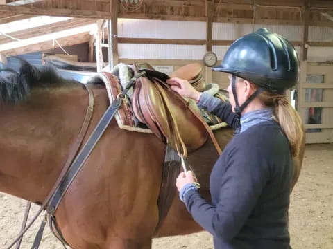 a person with a helmet on a horse
