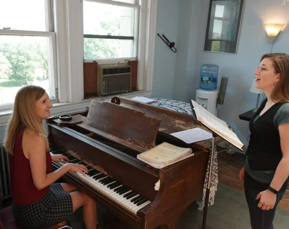 a woman playing a piano