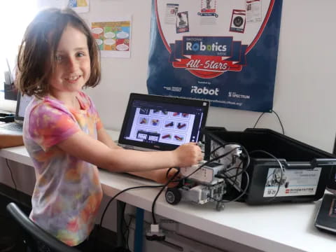 a girl holding a laptop