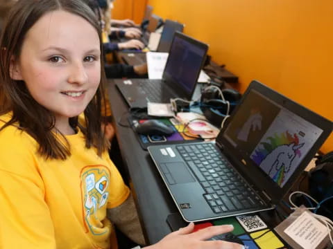 a young girl using a laptop
