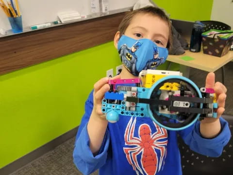 a child holding a toy gun
