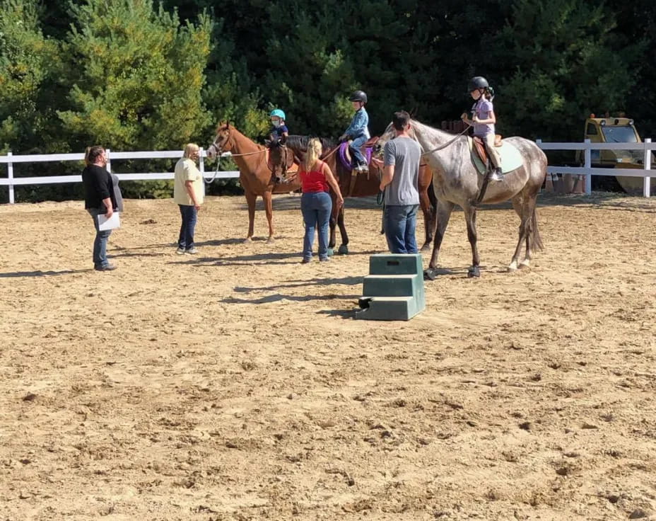 people riding horses in a field