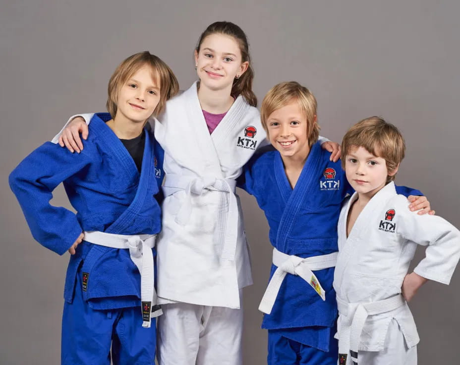 a group of girls in karate uniforms