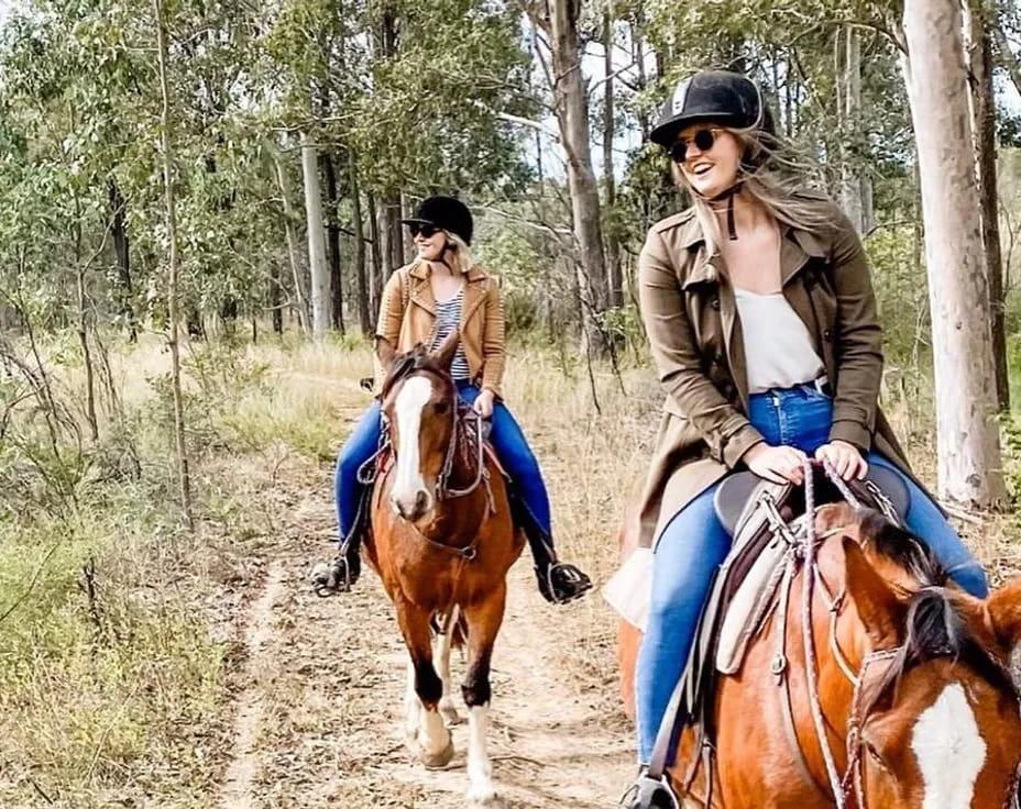 two women riding horses