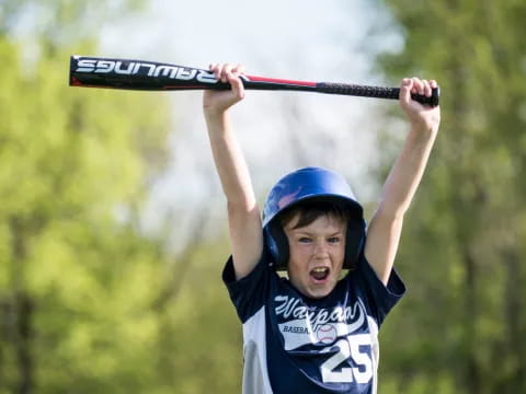 a kid holding a baseball bat