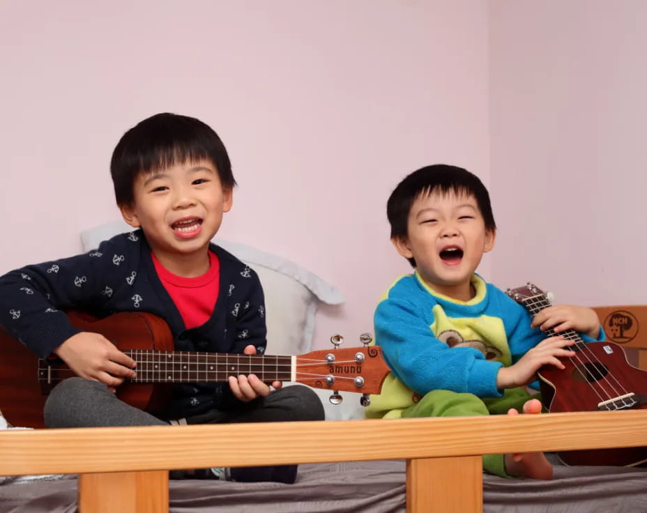 two boys holding guitars