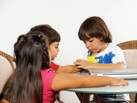a few children sitting at a table