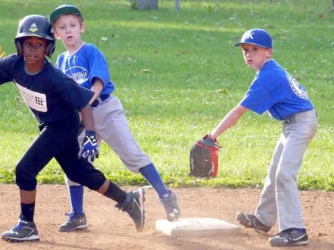 kids playing baseball on a field