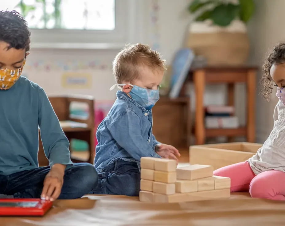 a few children playing with blocks