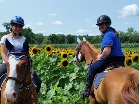 two women riding horses