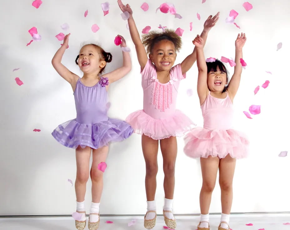 a group of girls in dresses