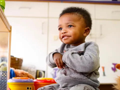 a baby in a grey sweater