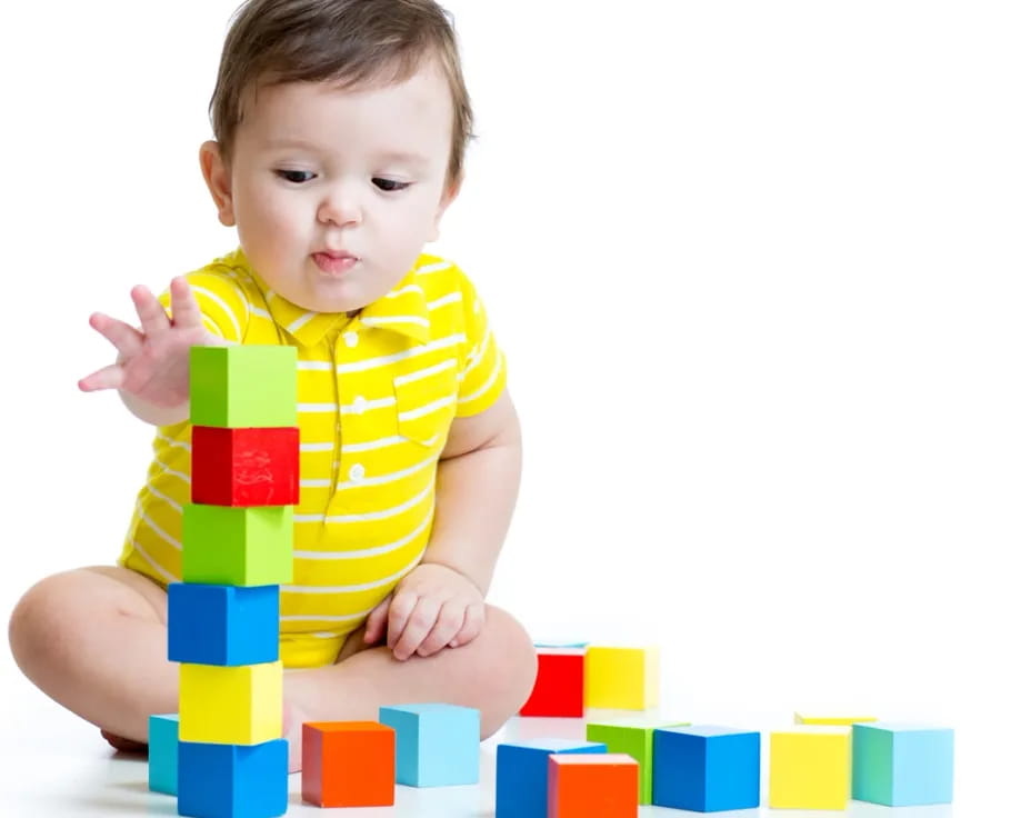 a baby sitting on a pile of blocks